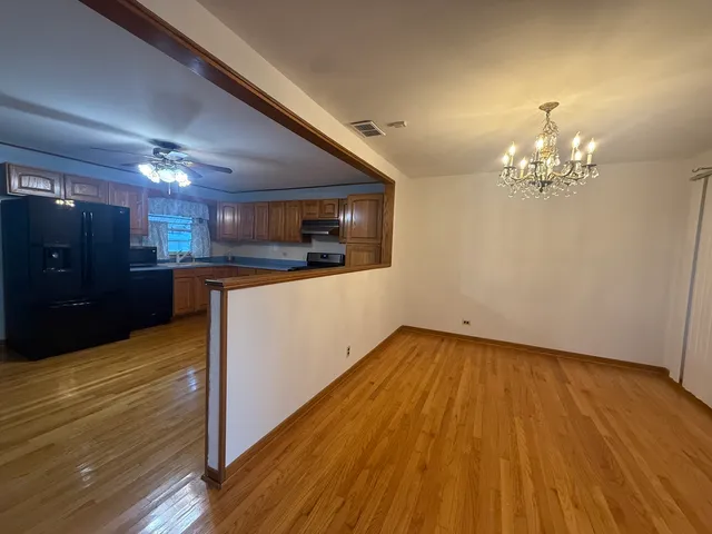 a view of a kitchen with cabinets and wooden floor