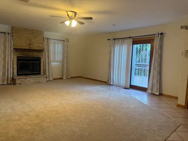 a view of empty room with a fireplace