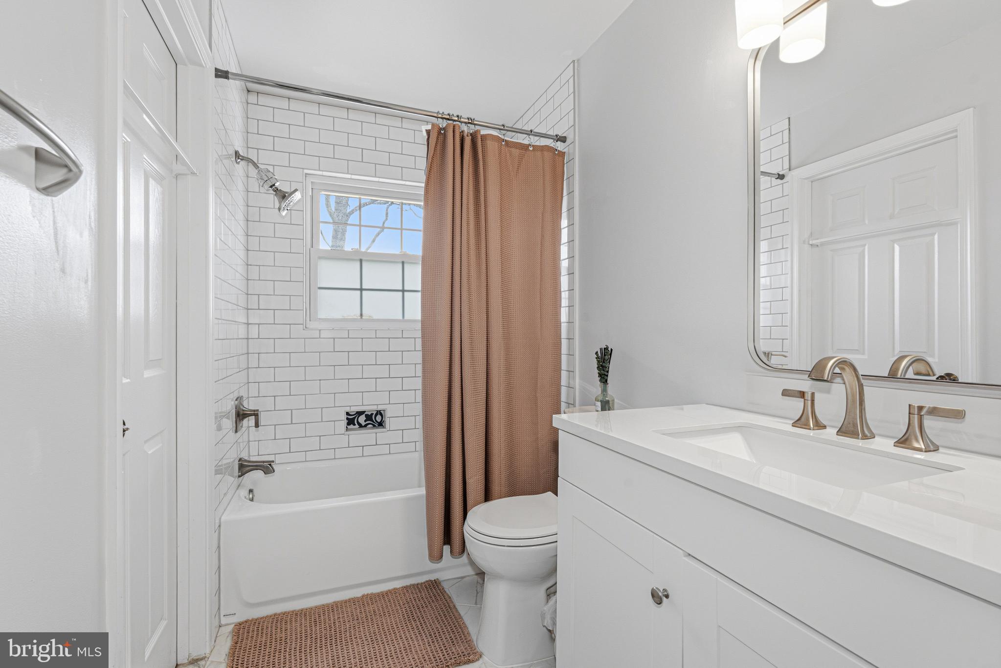 243 9th Street Pasadena, MD 21122 - Photo 21 of 41 a bathroom with a sink a toilet and shower