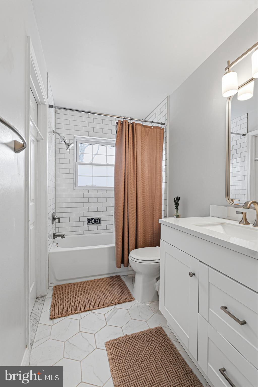 243 9th Street Pasadena, MD 21122 - Photo 22 of 41 a bathroom with a granite countertop sink a toilet and shower