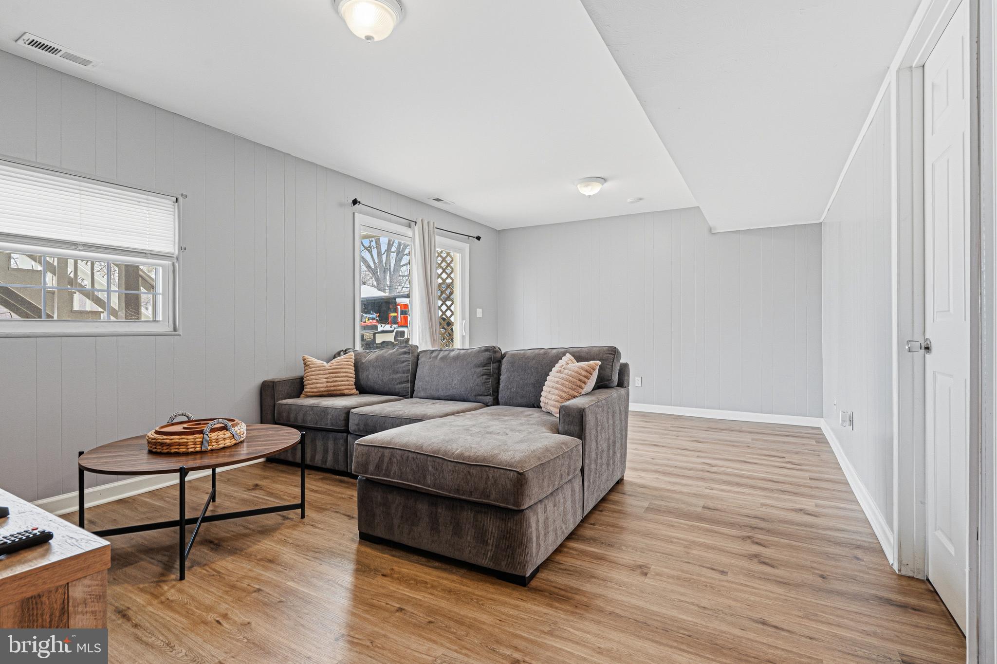 243 9th Street Pasadena, MD 21122 - Photo 28 of 41 a living room with furniture and a wooden floor