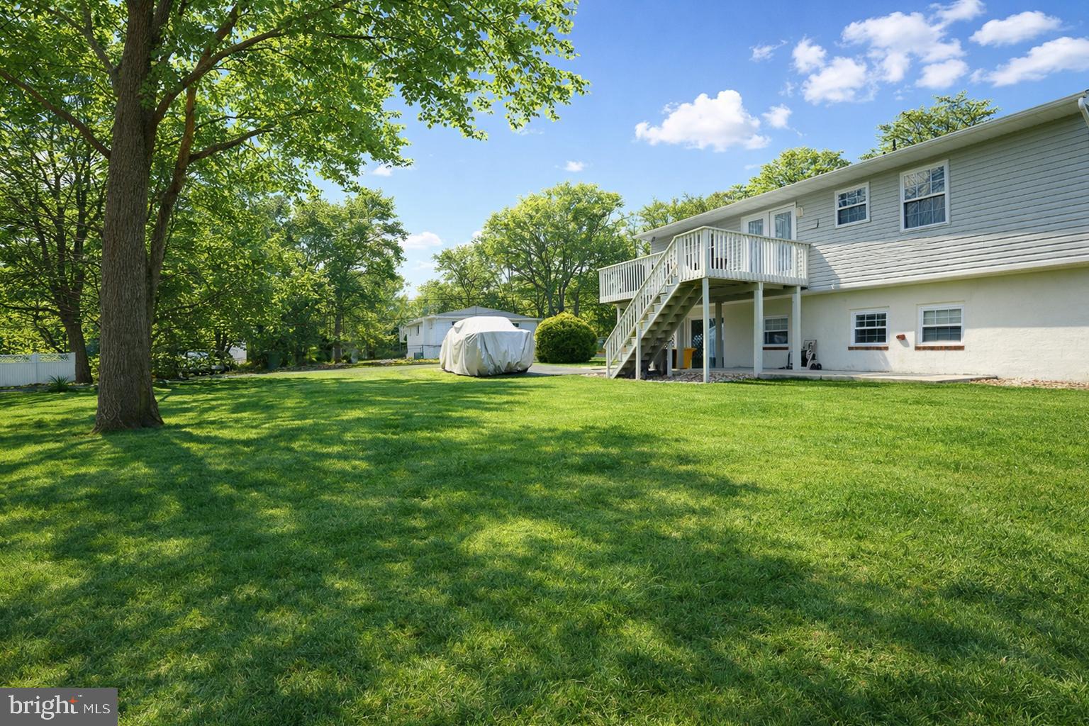 243 9th Street Pasadena, MD 21122 - Photo 5 of 41 a view of a house with a big yard and large trees