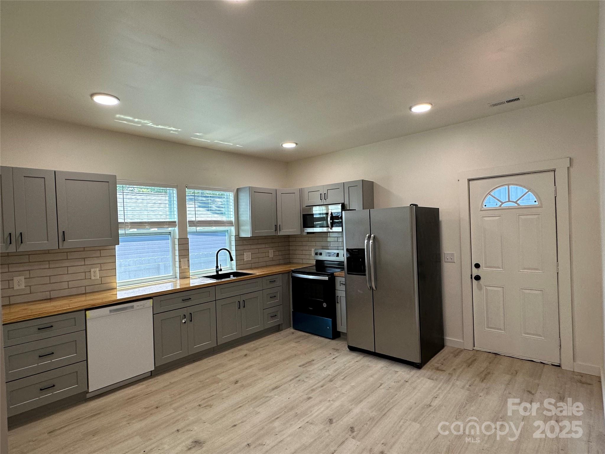 1409 Enochville Road Kannapolis, NC 28081 - Photo 2 of 14 a kitchen with stainless steel appliances granite countertop a refrigerator and a stove top oven