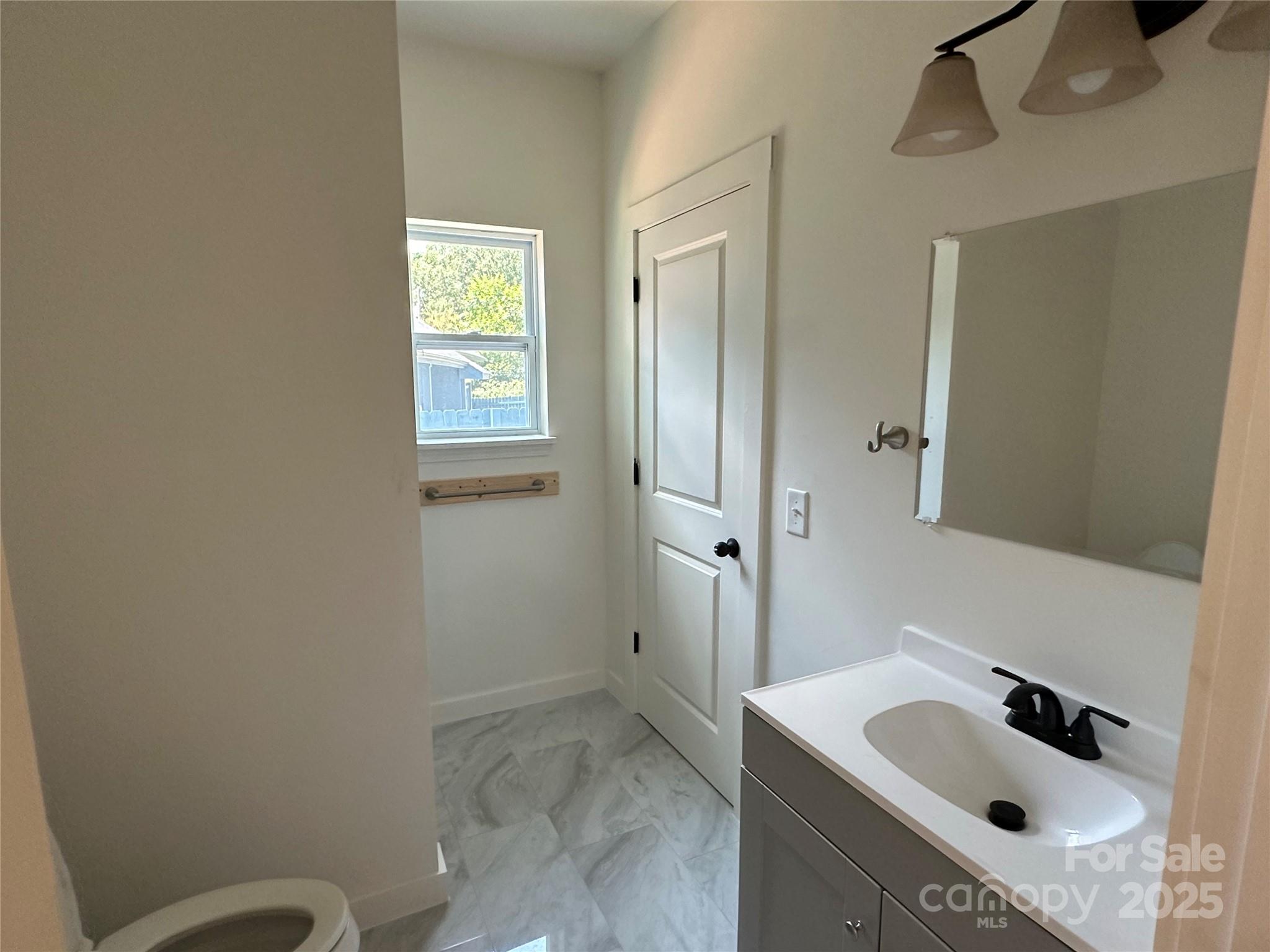 1409 Enochville Road Kannapolis, NC 28081 - Photo 6 of 14 a bathroom with a sink toilet and shower