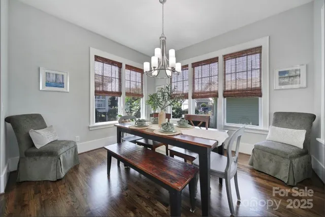 a view of a dining room with furniture wooden floor and chandelier