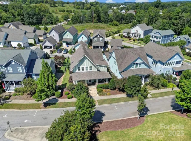 an aerial view of multiple houses with yard