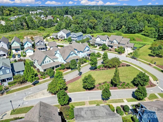 an aerial view of a houses with a yard