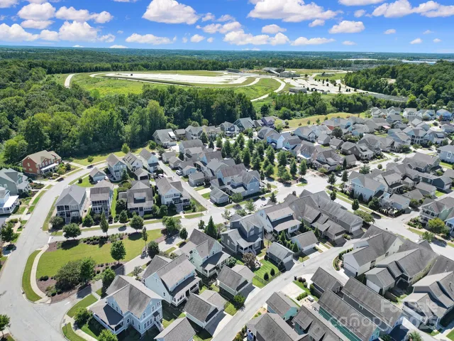 an aerial view of residential houses with outdoor space and ocean view