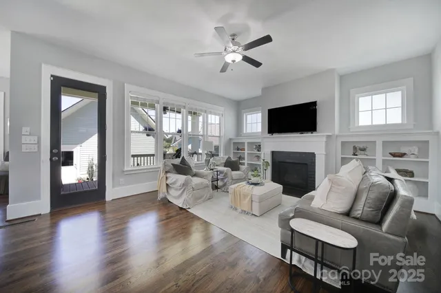 a living room with furniture a fireplace and a flat screen tv