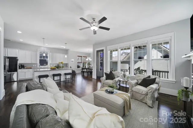 a living room with furniture and a view of kitchen