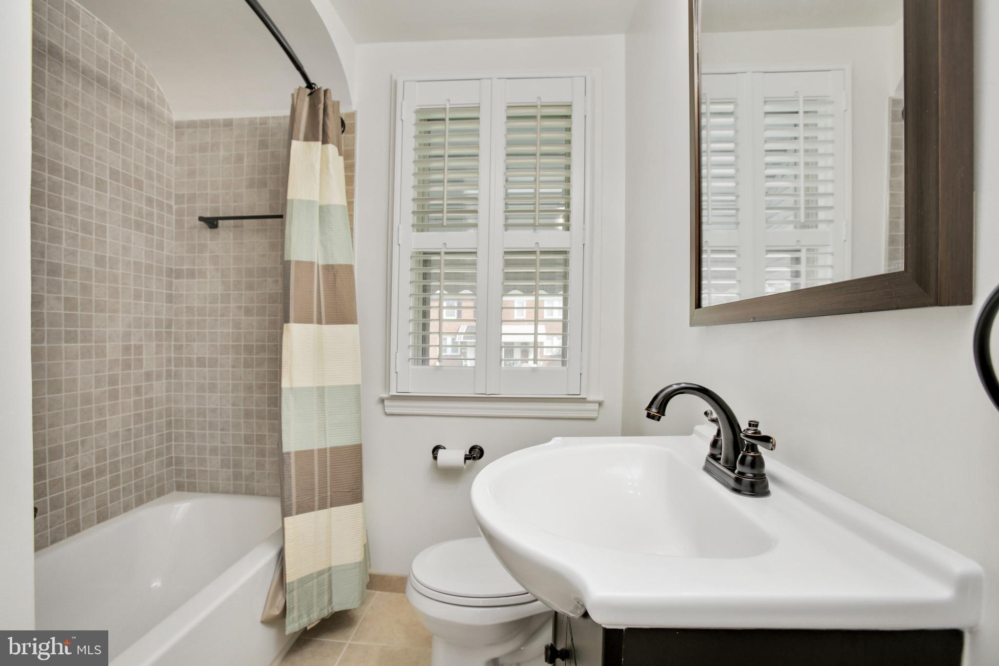 5021 West Hills Road Baltimore, MD 21229 - Photo 15 of 25 a bathroom with a sink a toilet and shower