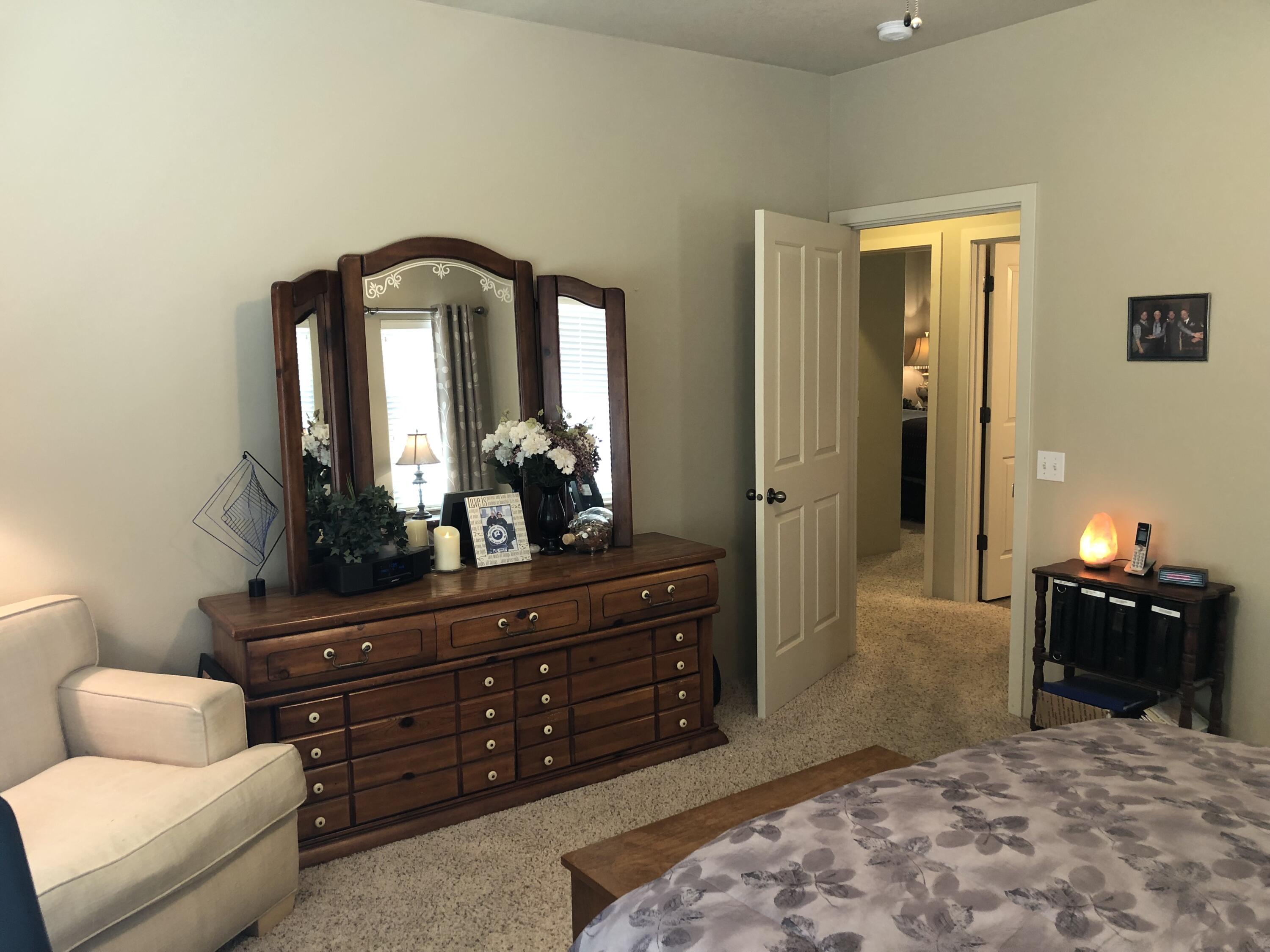 705 Three Pines Road Grants Pass, OR 97526 - Photo 39 of 47 a bedroom with a bed and a mirror on dresser