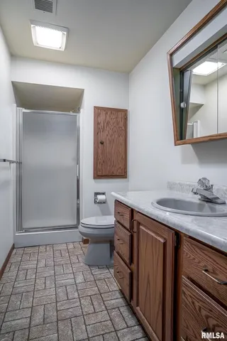 a bathroom with a sink a toilet and mirror