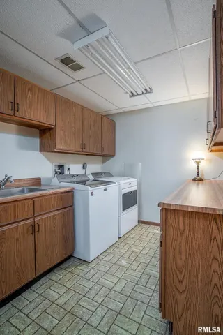 a kitchen with a sink a stove cabinets and a window