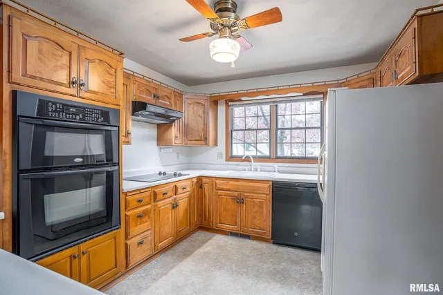 a kitchen with stainless steel appliances granite countertop a stove and a sink