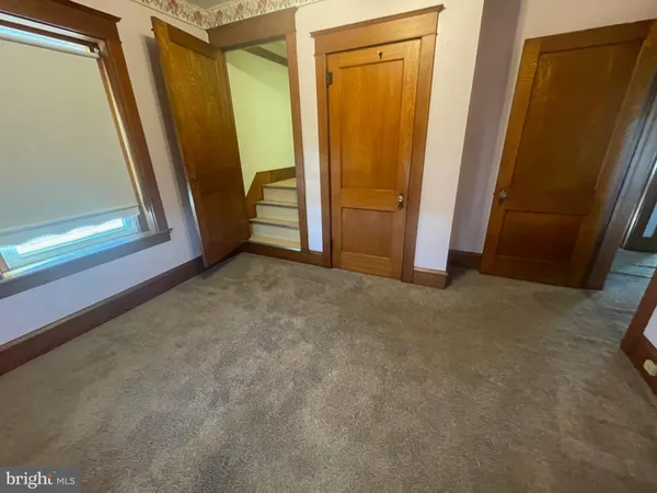 an empty room with a empty space and windows