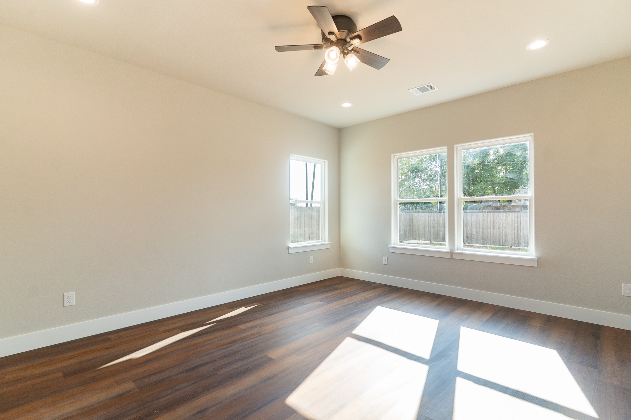 305 String Prairie Way Smithville, TX 78957 - Photo 12 of 26 a view of empty room with wooden floor and fan