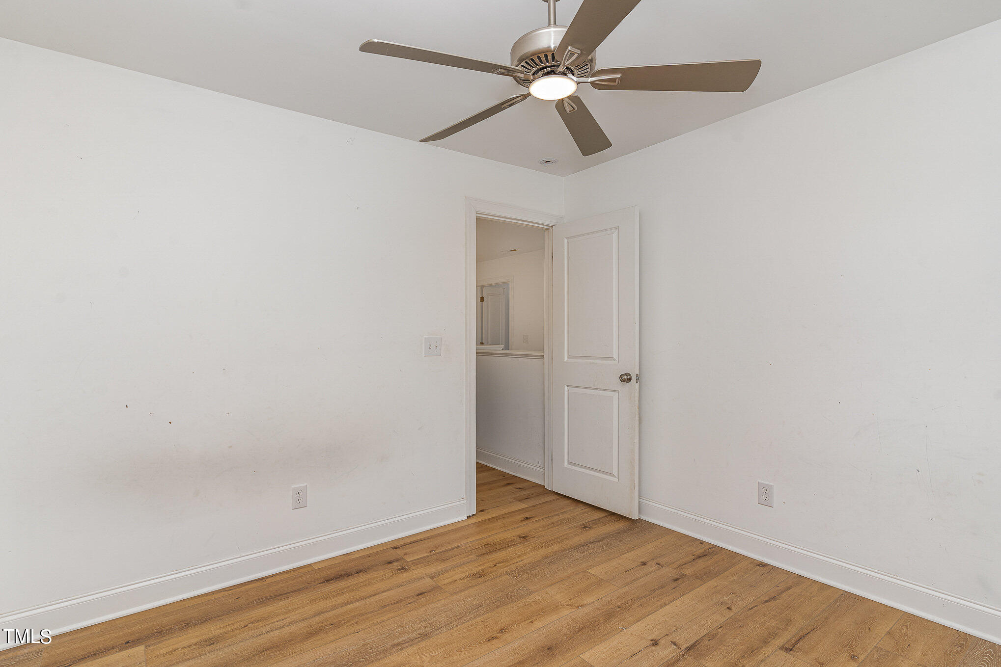 125 Holyoke Court Raleigh, NC 27603 - Photo 18 of 30 an empty room with wooden floor fan and windows