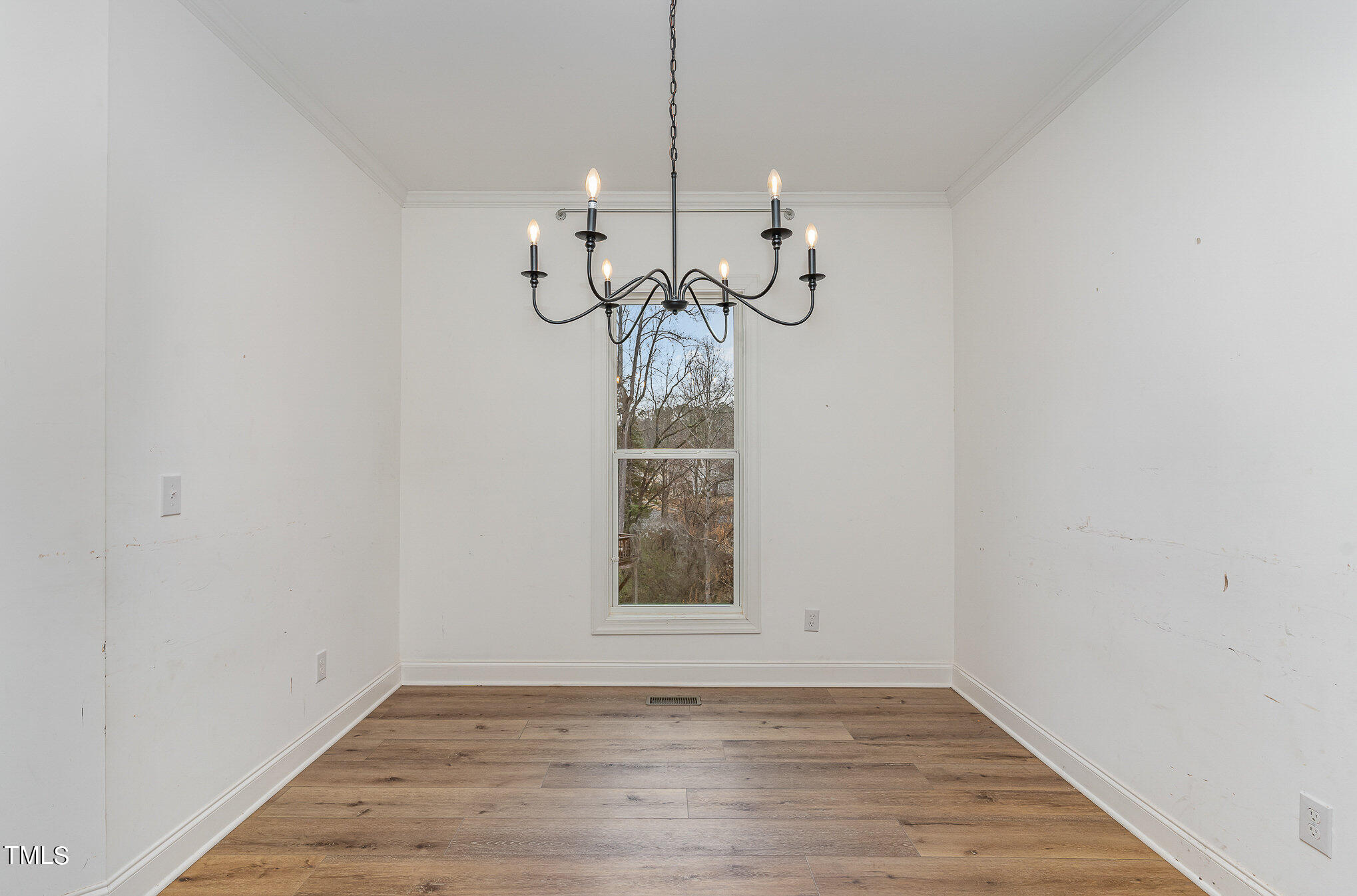 125 Holyoke Court Raleigh, NC 27603 - Photo 8 of 30 a view of a hallway with wooden floor and a chandelier