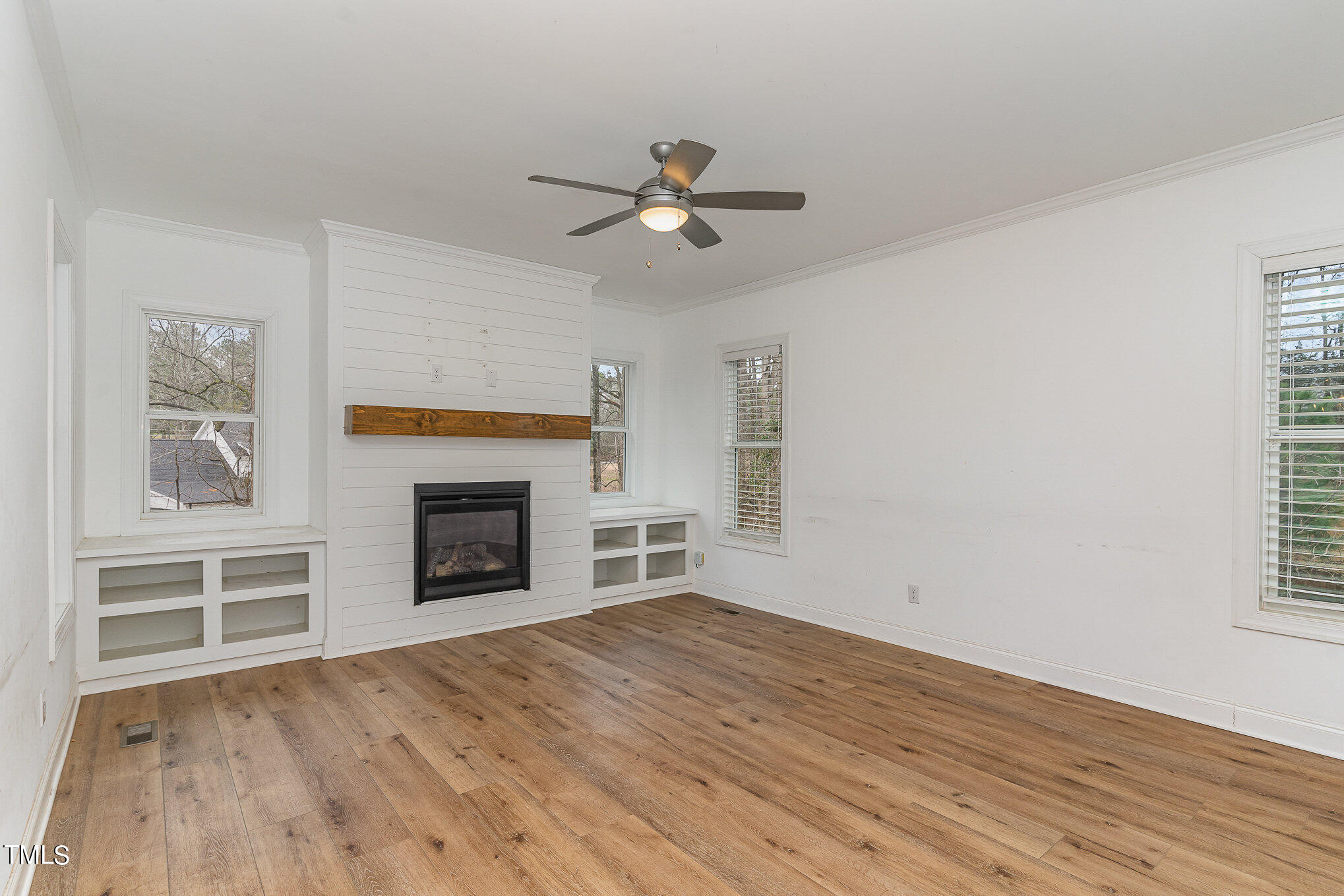 125 Holyoke Court Raleigh, NC 27603 - Photo 9 of 30 an empty room with windows and fireplace