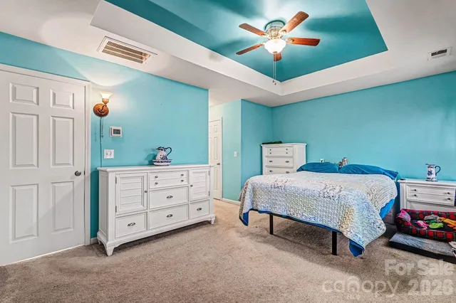 a bed room with a bed and a chandelier