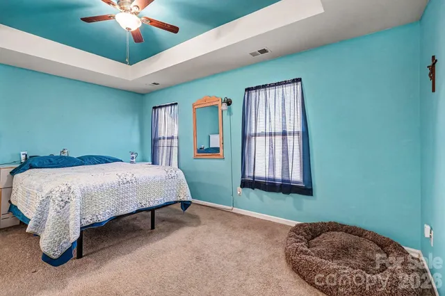 a bathroom with a double vanity sink a toilet and a mirror