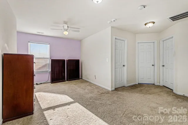 a view of room with window and ceiling fan