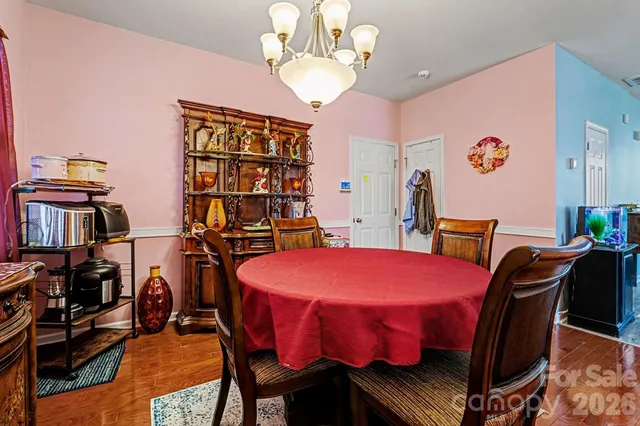 a kitchen with granite countertop a stove a sink and a refrigerator