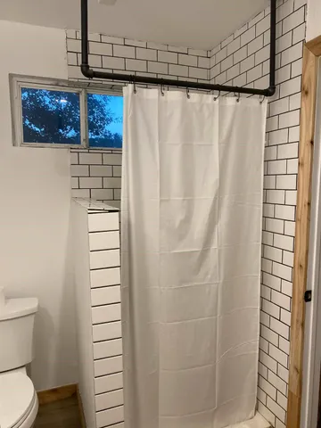 a bathroom with a shower and a toilet