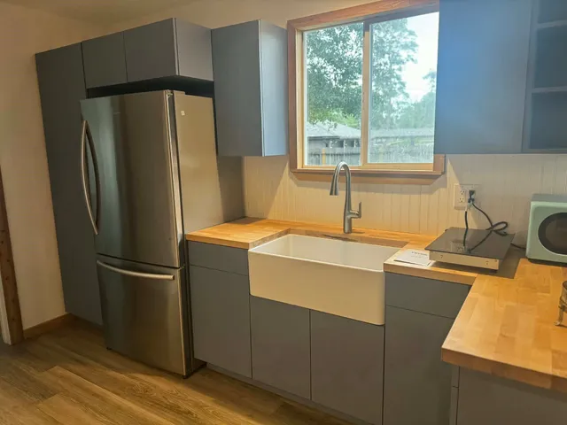 a kitchen with stainless steel appliances a refrigerator and a sink
