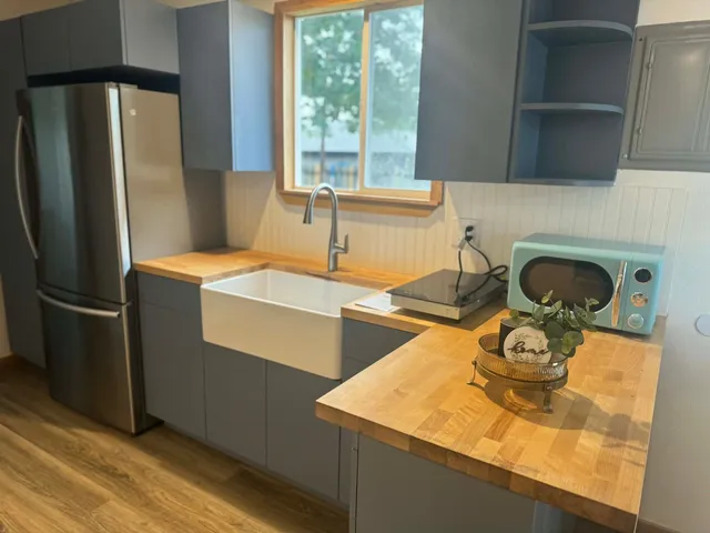 a kitchen with a sink a refrigerator and a stove