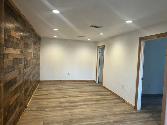 a view of hallway with wooden floor