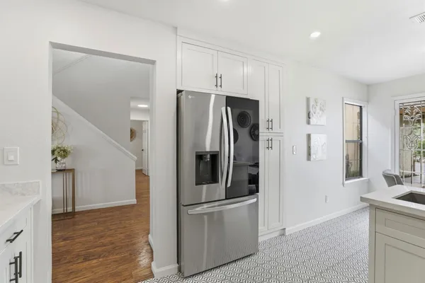a kitchen with stainless steel appliances granite countertop a refrigerator and a sink