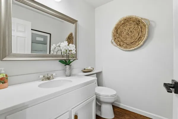 a bathroom with a toilet sink and mirror
