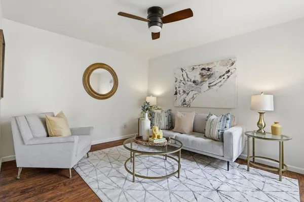 a living room with furniture and a wooden floor
