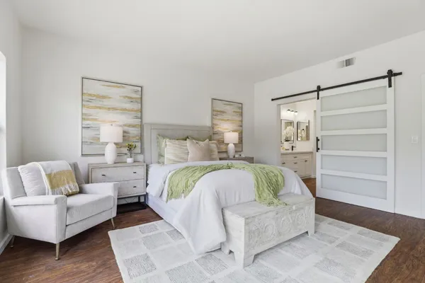 a bedroom with a bed and a couch