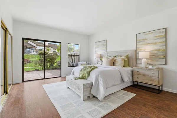 a bed room with a bed and a large window