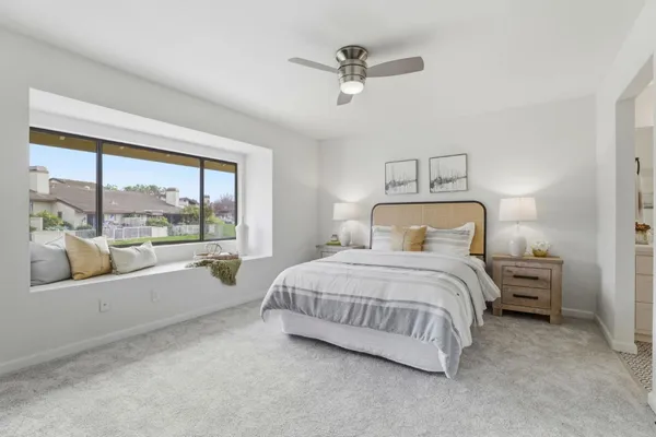 a bedroom with a large bed and a large window
