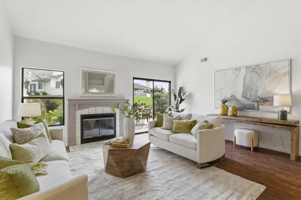 a living room with furniture and a fireplace