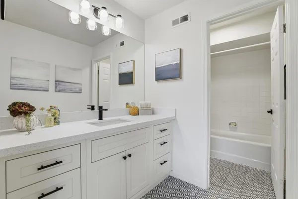 a bathroom with a double vanity sink a mirror and shower
