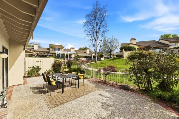 a view of a patio with table and chairs and potted plants