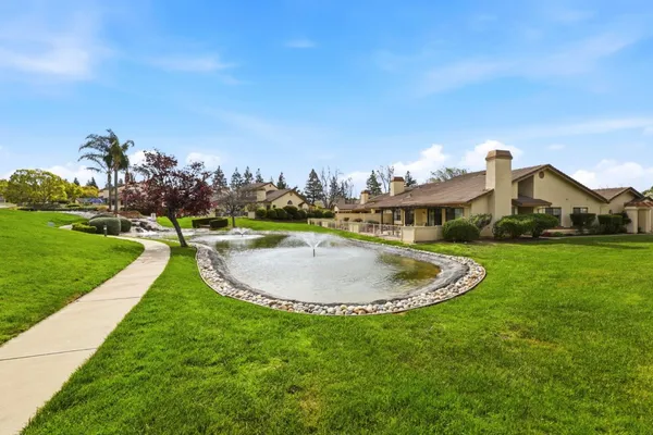 a swimming pool with outdoor seating and garden
