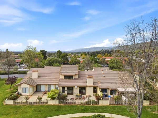 a aerial view of multiple houses with yard
