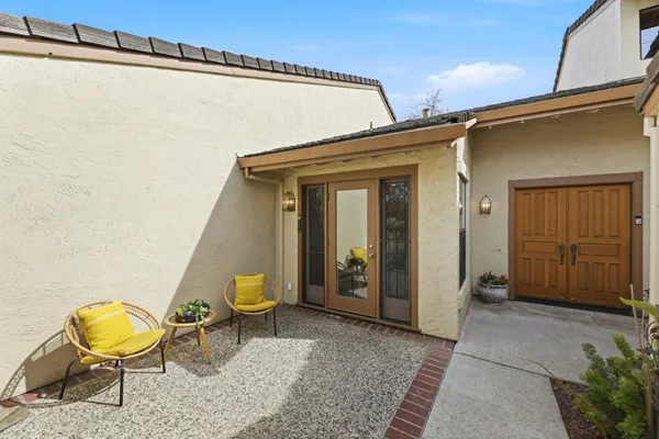a front view of a house with outdoor seating