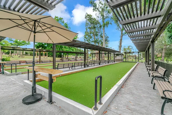a view of a swimming pool with a patio and a yard