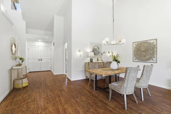 a view of a dining room with furniture wooden floor and chandelier