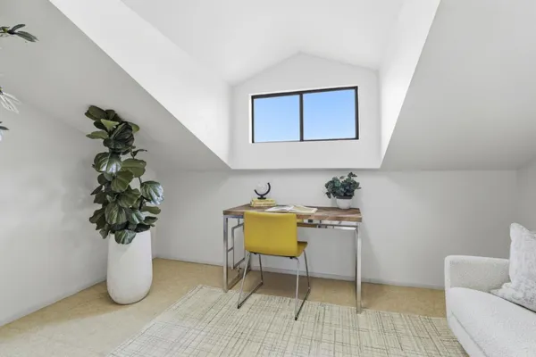 a view of living room with furniture and flowers