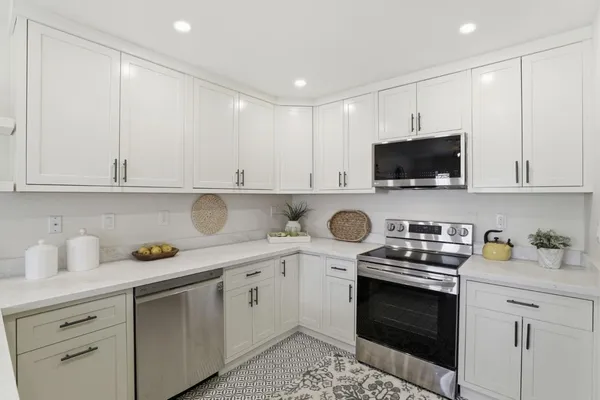a kitchen with a sink stove and microwave