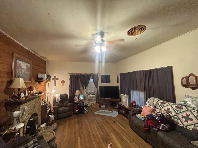 a view of a livingroom with furniture and a fan