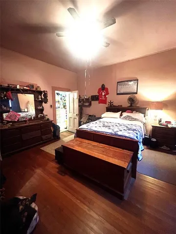a bedroom with a bed and a tv on dresser